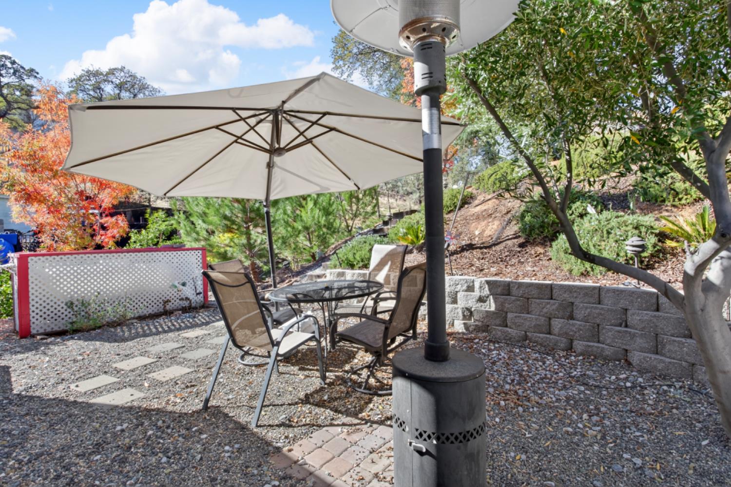 4856 Kiva Drive Copperopolis, CA 95228 - Photo 57 of 61 a view of a patio with table and chairs under an umbrella