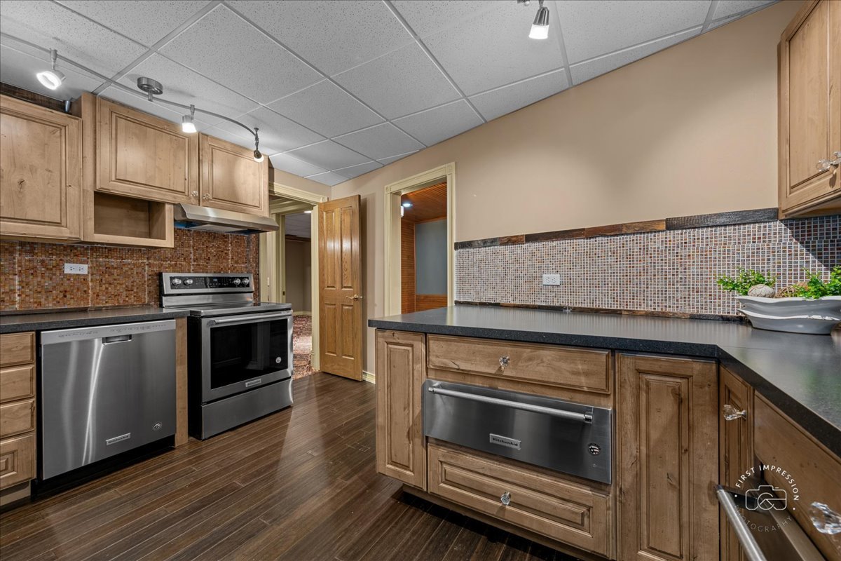 5N214 Wilton Croft Road St. Charles, IL 60175 - Photo 25 of 37 a kitchen with granite countertop a stove top oven and cabinets