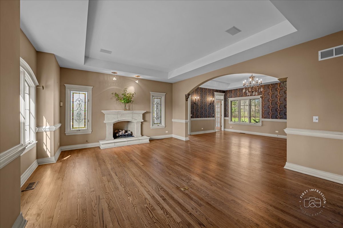 5N214 Wilton Croft Road St. Charles, IL 60175 - Photo 6 of 37 wooden floor in an empty room with a fireplace