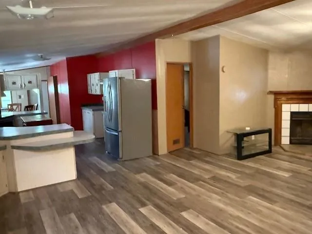 a view of a a dining room with furniture window and wooden floor