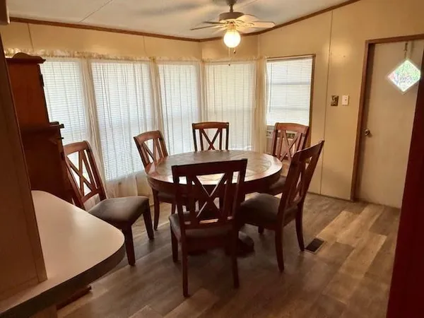 a living room with stainless steel appliances granite countertop furniture and a large window