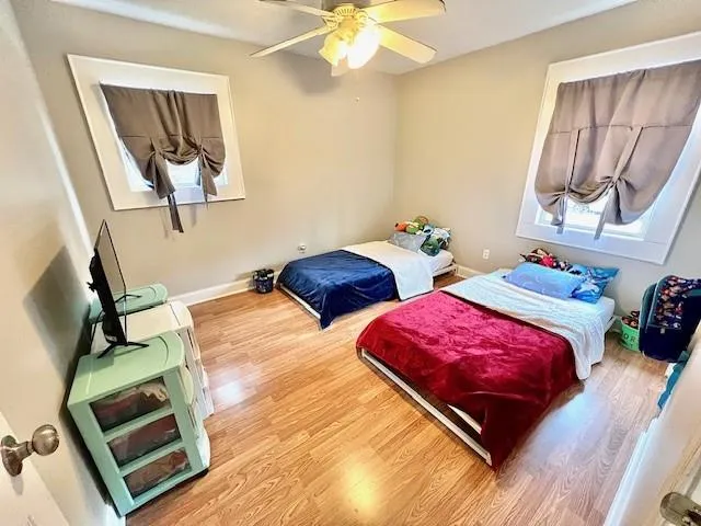 a bedroom with two beds and painting on the wall