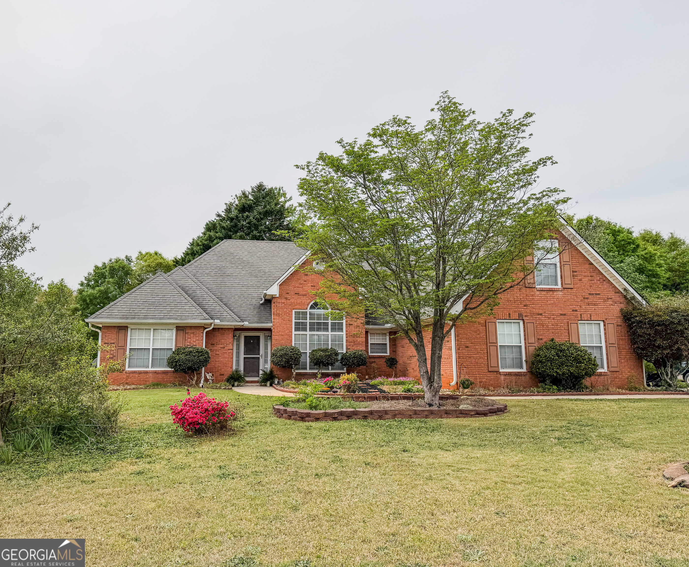a front view of house with yard and trees