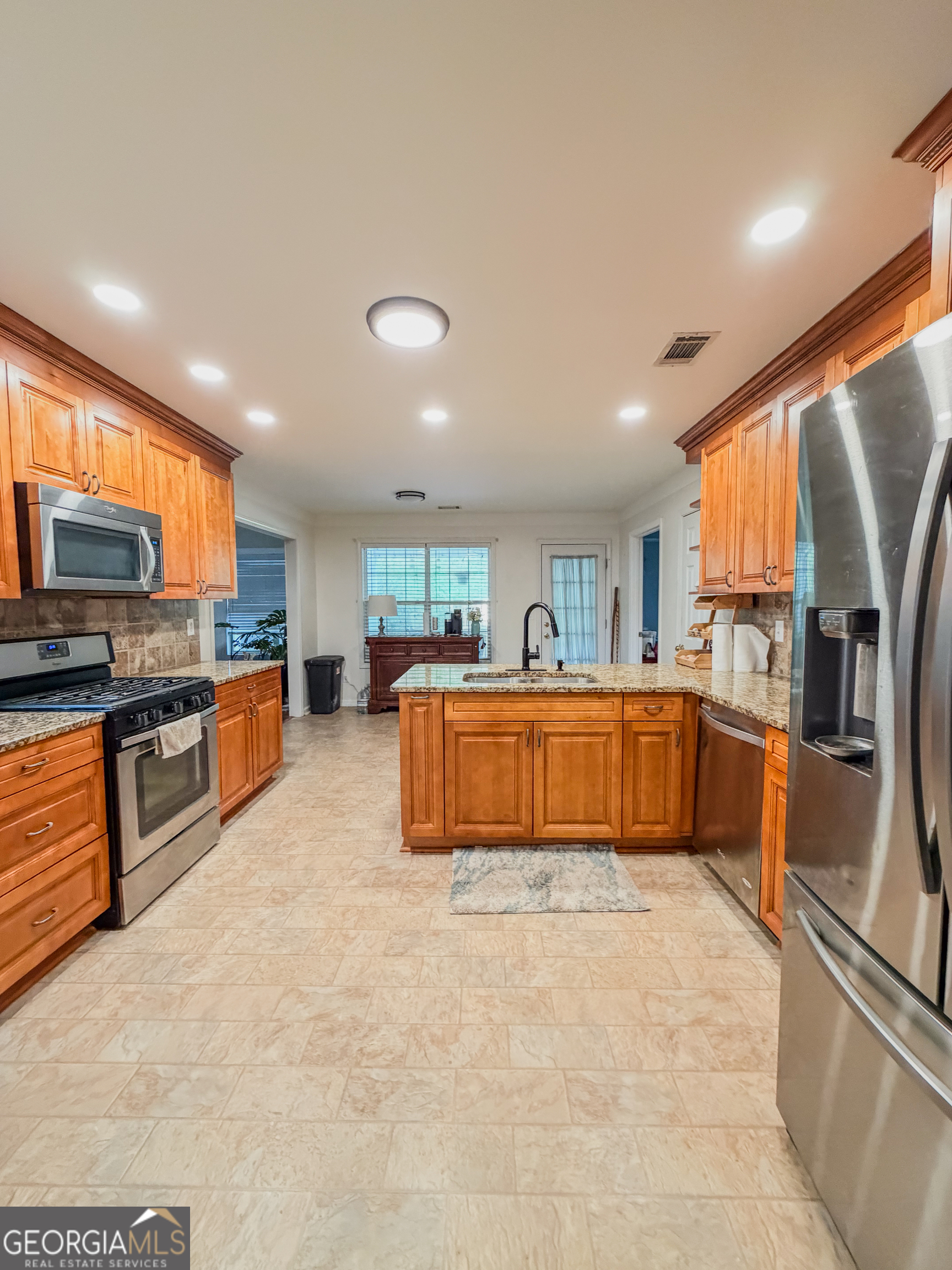 408 Mosby Lane Locust Grove, GA 30248 - Photo 7 of 17 a large kitchen with stainless steel appliances kitchen island granite countertop a large counter top stainless steel appliances and cabinets