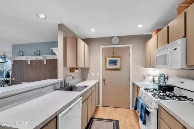 a kitchen with stainless steel appliances a sink stove and cabinets