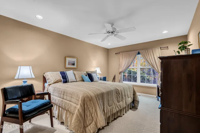 a bedroom with a bed a window and a chandelier