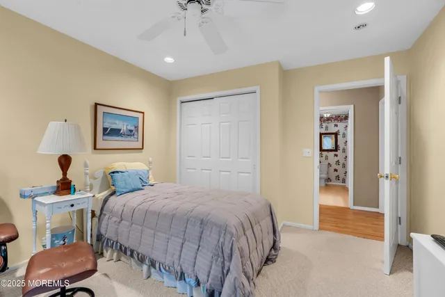 a bedroom with a bed and a mirror