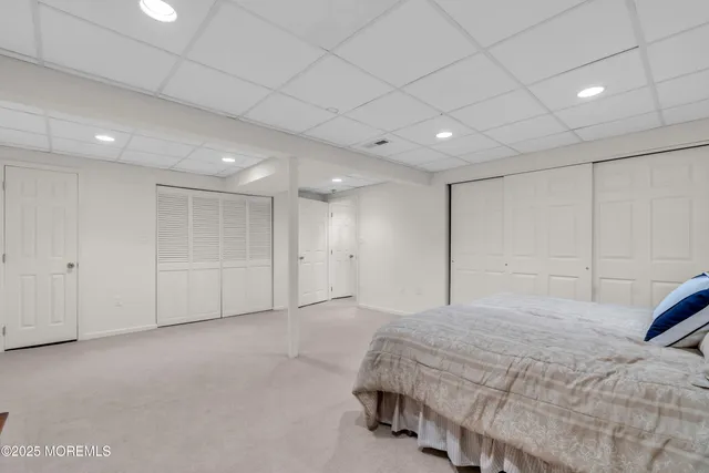 a spacious bedroom with a bed and a walk in closet