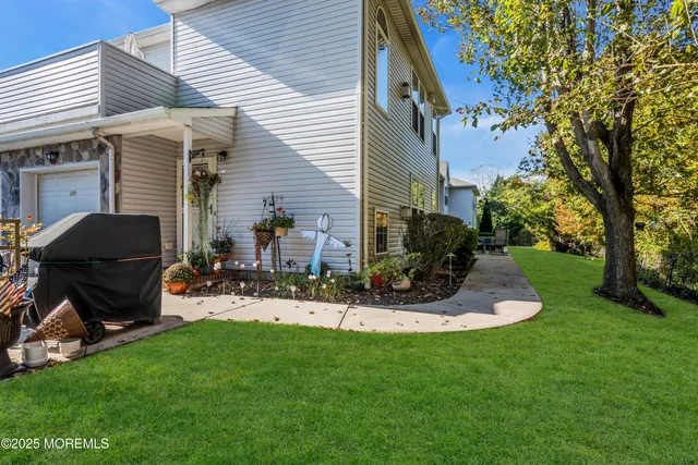 a view of a chair and table in backyard of the house