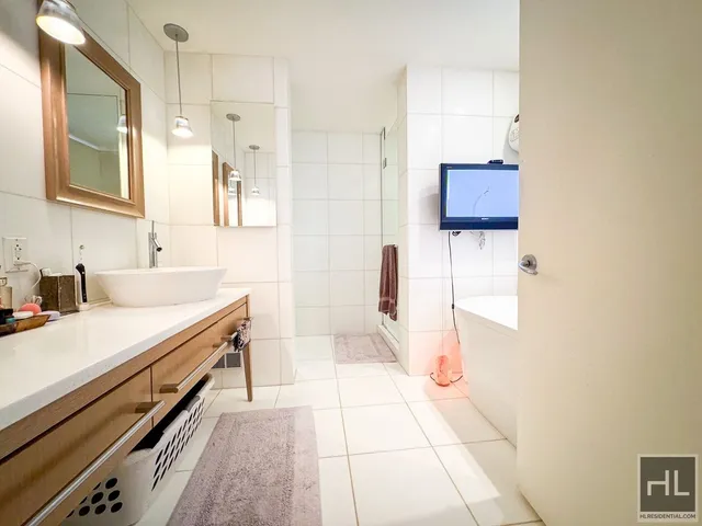 a bathroom with a sink a toilet and mirror