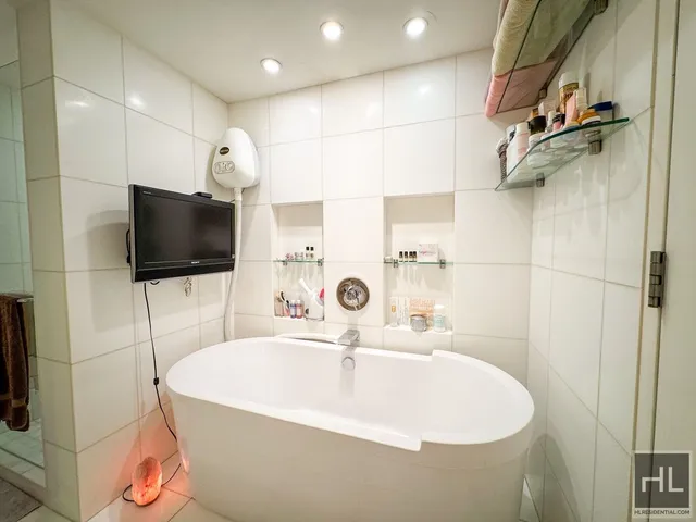 a bathroom with a sink a mirror and shower