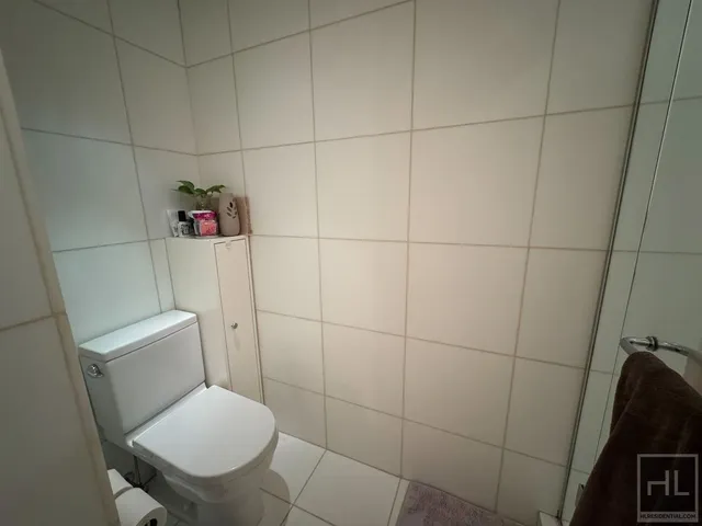 a white toilet sitting next to a bathroom sink