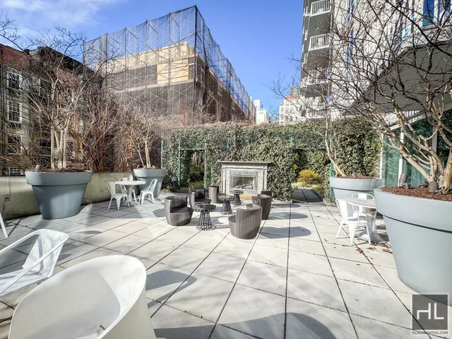 a view of a patio with couches and table and chairs and potted plants