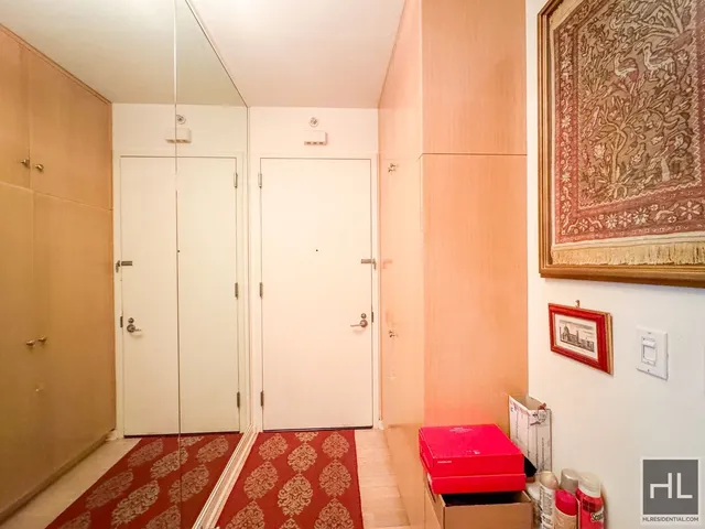 a bedroom with furniture and a flat screen tv