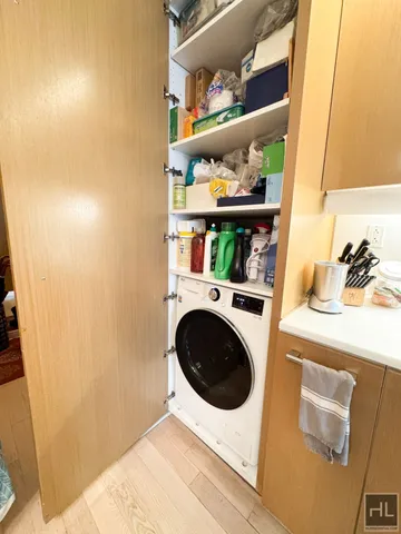 a kitchen with a sink a stove cabinets and a wooden floor