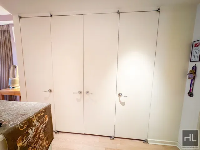 a view of a hallway with wooden floor and entryway