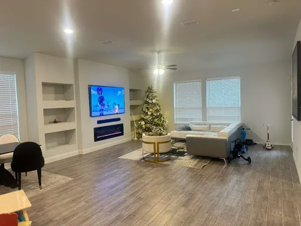 a living room with furniture and a potted plant