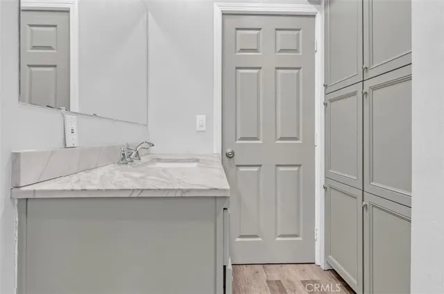 a bathroom with a granite countertop sink and a mirror