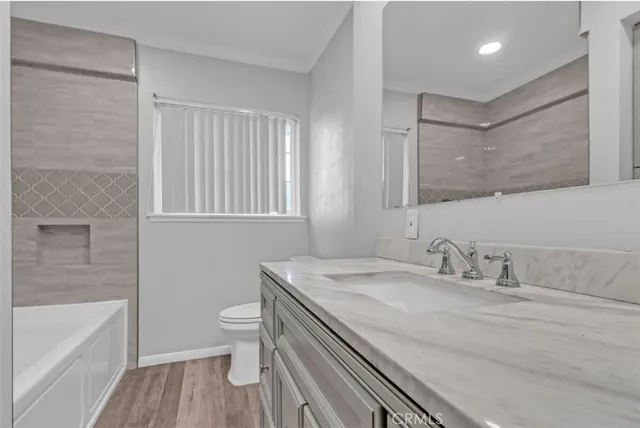 a bathroom with a sink a toilet and bathtub