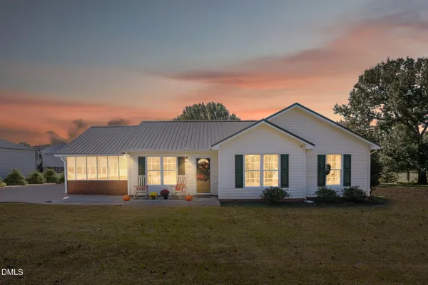 a front view of a house with a garden
