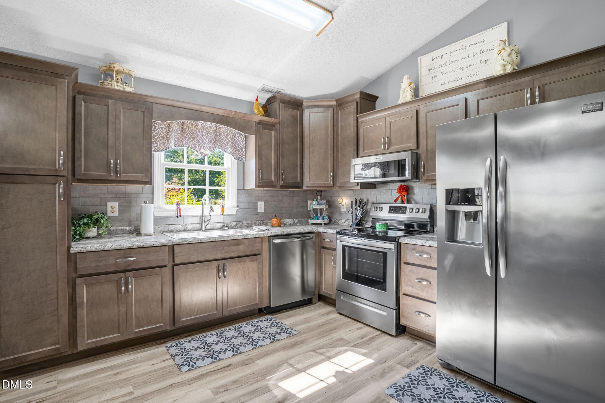 5626 Preston Loop Mebane, NC 27302 - Photo 14 of 33 a kitchen with stainless steel appliances granite countertop a refrigerator a sink a stove and cabinets