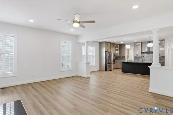 a view of a kitchen with a sink and wooden floor