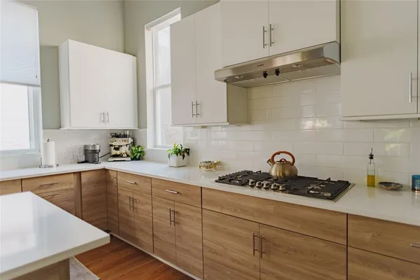 a kitchen with sink a stove and cabinets