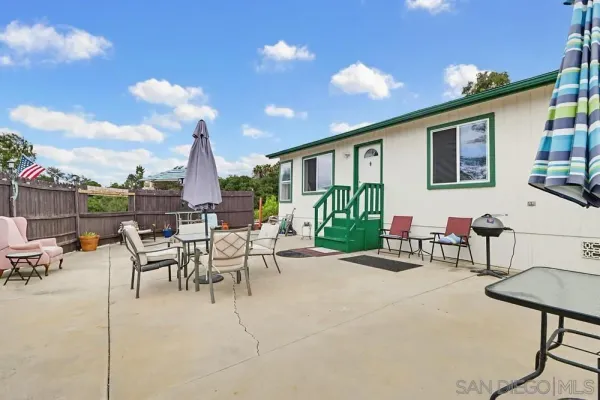 a view of a patio with a table and chairs