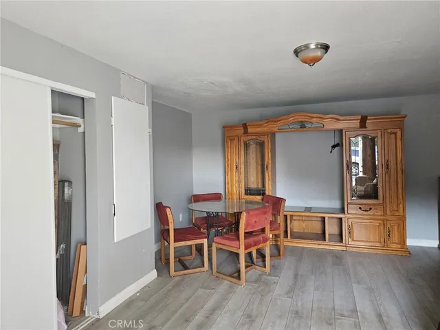a dining room with furniture and wooden floor