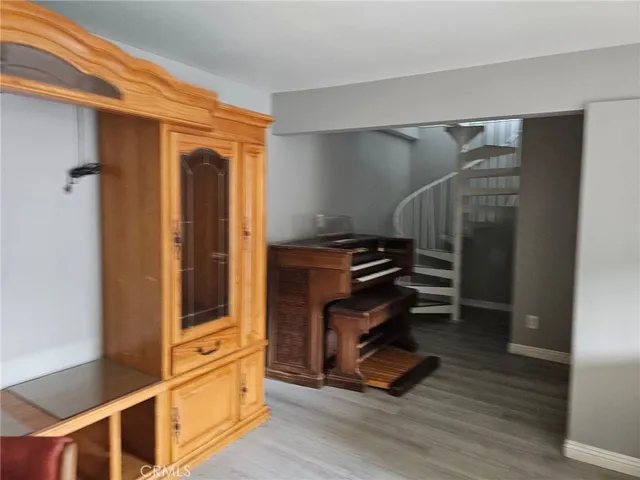 a room with wooden floor and furniture