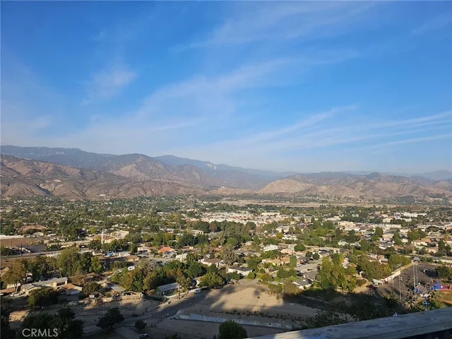 an aerial view of residential houses with city view