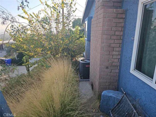 a view of brick house with a yard