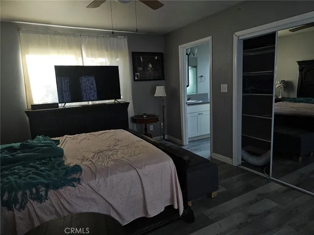 a bedroom with a bed and a television