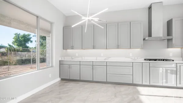 a kitchen with stainless steel appliances a refrigerator a stove and white cabinets