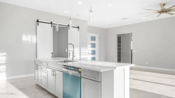 a kitchen with stainless steel appliances granite countertop a refrigerator a sink and a stove