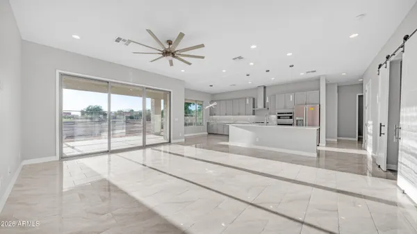 a large white kitchen with a large window