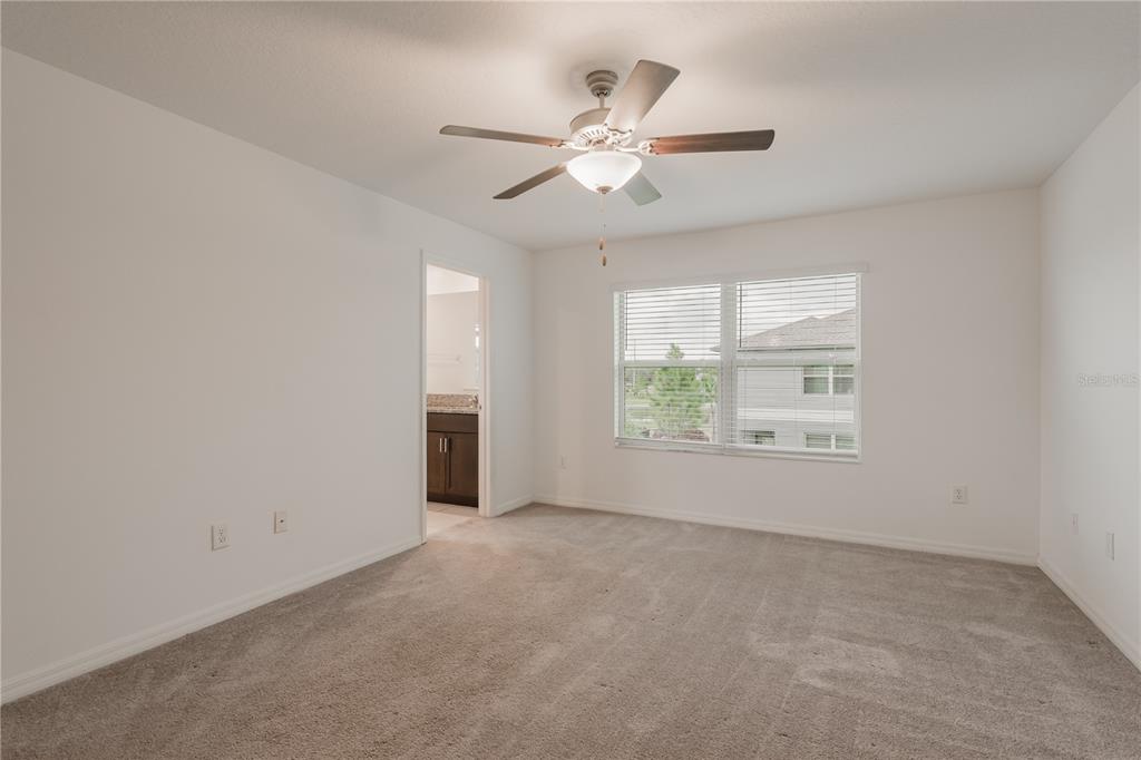 14302 Editors Note Street Ruskin, FL 33573 - Photo 14 of 44 an empty room with windows and chandelier fan