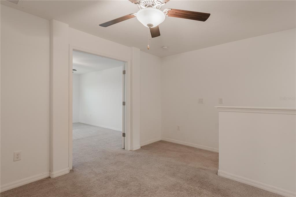 14302 Editors Note Street Ruskin, FL 33573 - Photo 15 of 44 an empty room with chandelier fan