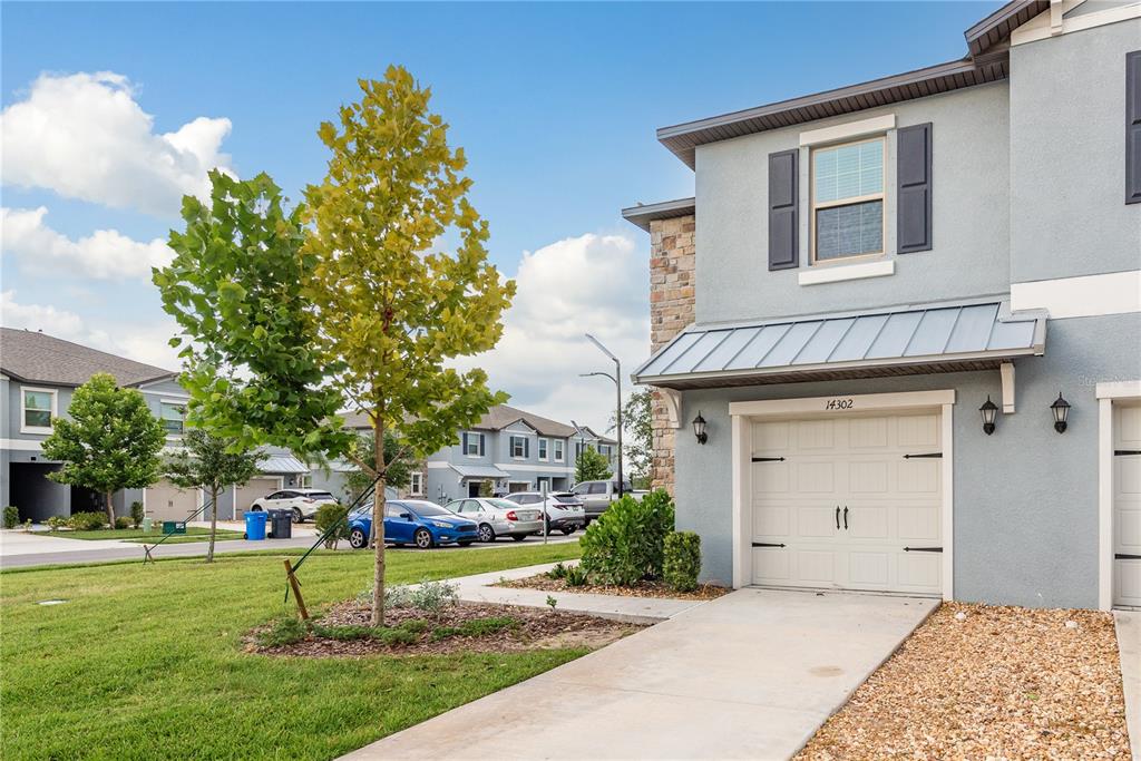 14302 Editors Note Street Ruskin, FL 33573 - Photo 2 of 44 a front view of a house with a yard