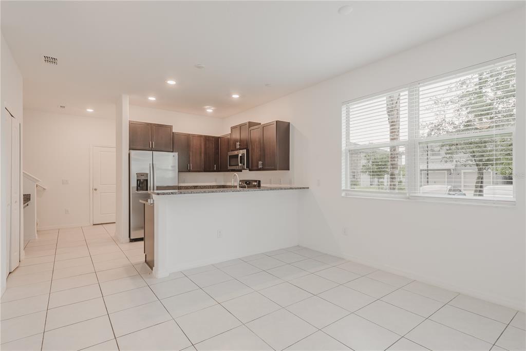 14302 Editors Note Street Ruskin, FL 33573 - Photo 21 of 44 a view of kitchen with white cabinets and refrigerator