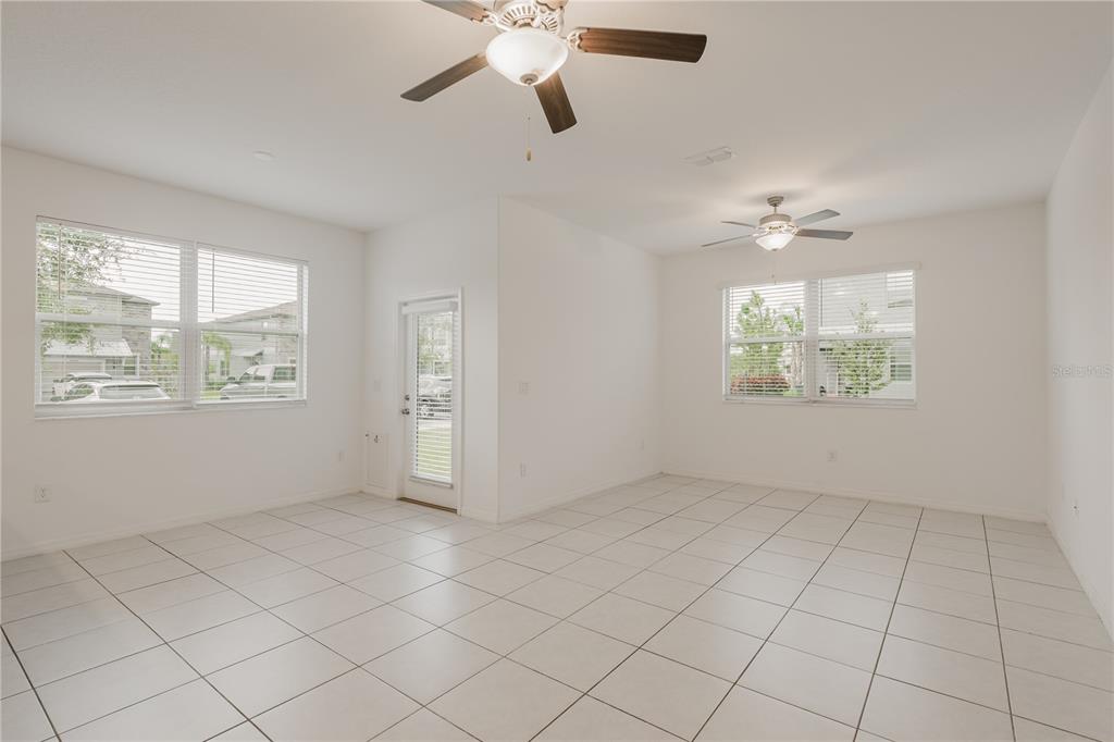 14302 Editors Note Street Ruskin, FL 33573 - Photo 25 of 44 an empty room with windows and fan