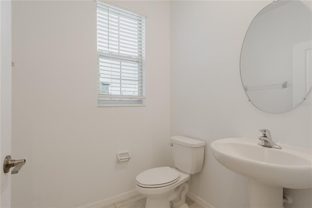 14302 Editors Note Street Ruskin, FL 33573 - Photo 27 of 44 a bathroom with a sink a toilet and a mirror