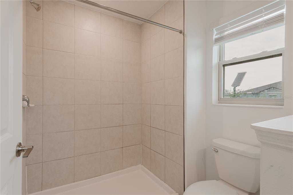 14302 Editors Note Street Ruskin, FL 33573 - Photo 6 of 44 a bathroom with a shower and a toilet