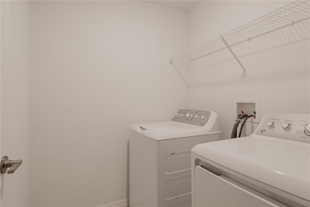 14302 Editors Note Street Ruskin, FL 33573 - Photo 7 of 44 a utility room with dryer and washer