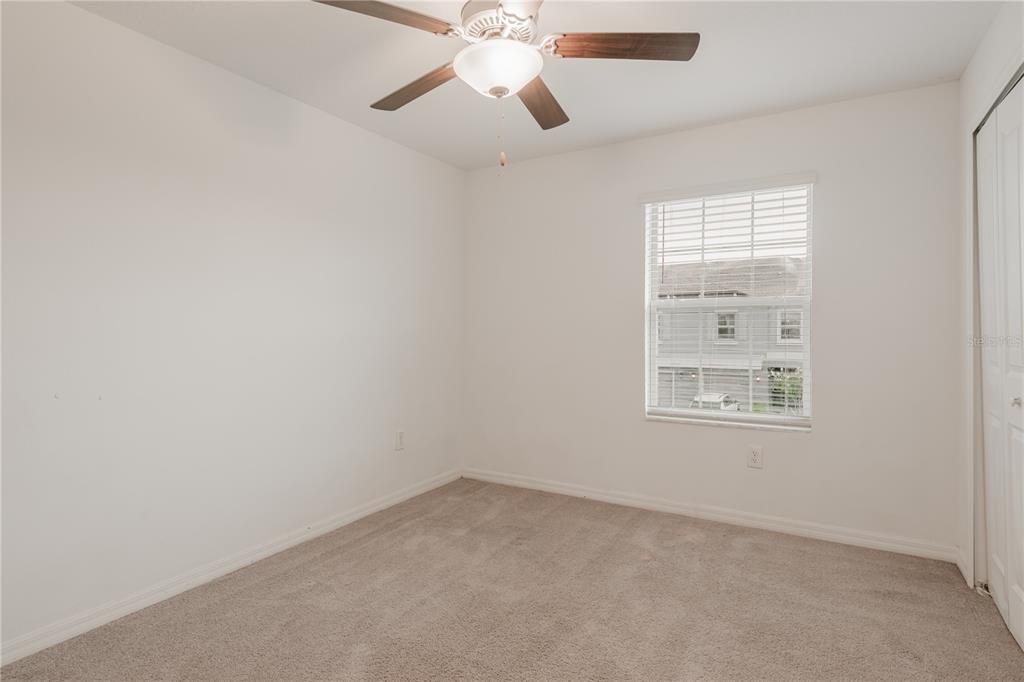 14302 Editors Note Street Ruskin, FL 33573 - Photo 8 of 44 an empty room with windows and fan