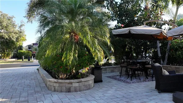 a view of a table and chairs in back yard of the house