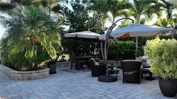 a view of a patio with couches and potted plants