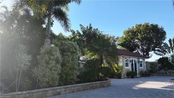 a view of house with outdoor space and garden