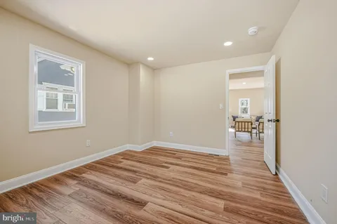 a view of a livingroom with wooden floor and a window