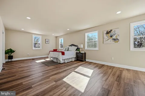 a spacious bedroom with a bed and a desk